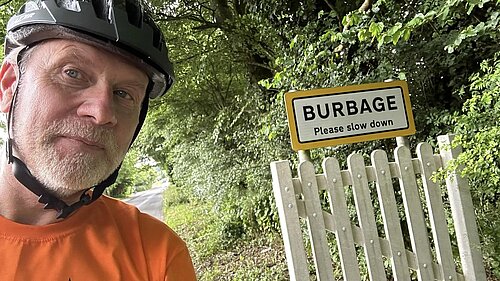 David Kinnaird with Burbage sign on his bike tour