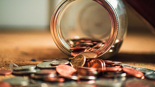 Coins coming out of a jar